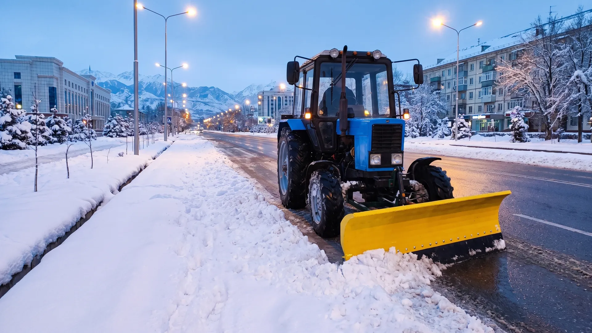 Tractor with an IMA-X municipal snow blade on a winter street